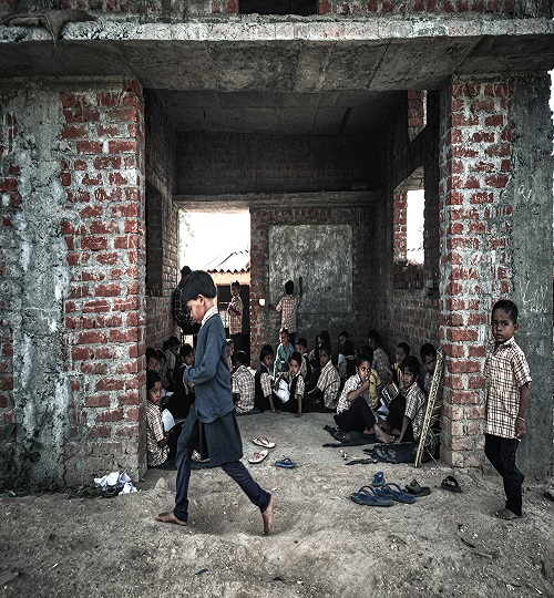 Canva - Children Sitting on Floor Inside Building and Another Two Children Walking
