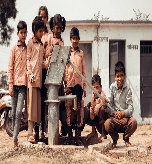 Canva - Children Standing next to Manual Water Pump